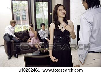 Stock Image - three young men 
and two young 
women chatting, 
sitting at home. 
fotosearch - search 
stock photos, 
pictures, images, 
and photo clipart