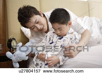 Picture - father and son 
playing with doll 
in bed. fotosearch 
- search stock 
photos, pictures, 
images, and photo 
clipart