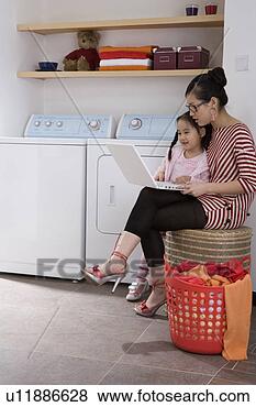 Stock Photo - mom and daughter 
playing with laptop 
in washhouse. 
fotosearch - search 
stock photos, 
pictures, images, 
and photo clipart