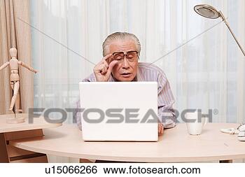Stock Photo - elderly man watching 
screen of laptop 
carefully. fotosearch 
- search stock 
photos, pictures, 
images, and photo 
clipart