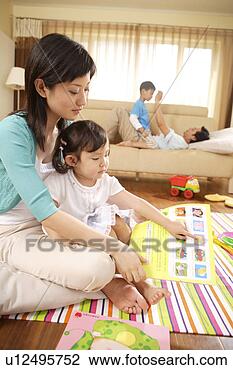 Stock Photo - family members 
reading and playing. 
fotosearch - search 
stock photos, 
pictures, images, 
and photo clipart