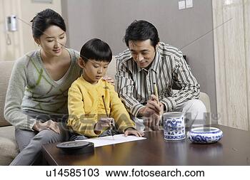 Stock Photo - father and mother 
looking at son 
who practising 
chinese calligraphy. 
fotosearch - search 
stock photos, 
pictures, images, 
and photo clipart