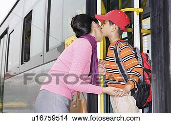 Stock Photo - son standing on 
bus and kissing 
mother. fotosearch 
- search stock 
photos, pictures, 
images, and photo 
clipart