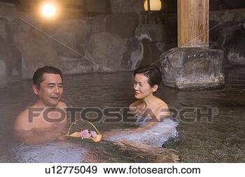Stock Photograph - mature adult couple 
taking a hot spring 
bath together, 
 side view. fotosearch 
- search stock 
photos, pictures, 
images, and photo 
clipart