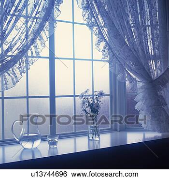 Stock Photo - flower and pitcher 
that is at the 
window, toned 
image, soft focus. 
fotosearch - search 
stock photos, 
pictures, images, 
and photo clipart