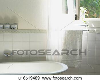 Stock Photograph - a bathroom with 
a white bathtub 
and a towel, high 
angle view. fotosearch 
- search stock 
photos, pictures, 
images, and photo 
clipart