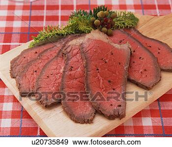 Stock Photograph - slices of roast 
beef on board, 
close-up. fotosearch 
- search stock 
photos, pictures, 
images, and photo 
clipart