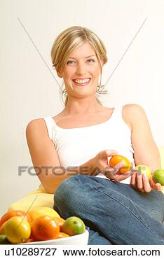 Picture - woman holding 
citrus fruit, 
fruit bowl in 
foreground. fotosearch 
- search stock 
photos, pictures, 
images, and photo 
clipart