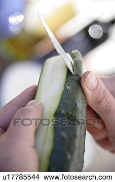 Stock Photo - peeling and slicing 
fresh cucmber 
for salad, close 
up. fotosearch 
- search stock 
photos, pictures, 
images, and photo 
clipart