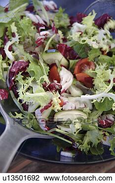 Stock Photo - preparing fresh 
salad: mixing 
everything in 
the salad bowl. 
fotosearch - search 
stock photos, 
pictures, images, 
and photo clipart
