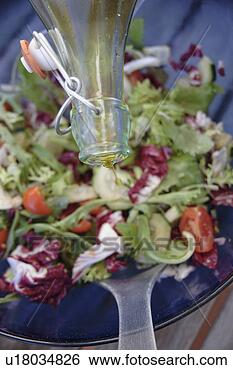 Stock Photo - preparing fresh 
salad: adding 
olive oil. fotosearch 
- search stock 
photos, pictures, 
images, and photo 
clipart