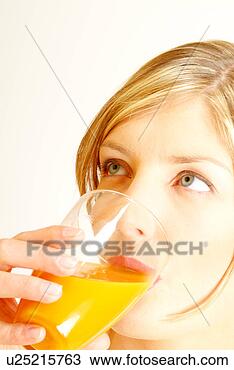 Stock Photo - close-up of woman 
drinking orange 
juice. fotosearch 
- search stock 
photos, pictures, 
images, and photo 
clipart