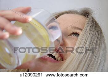 Stock Photography - young blond woman 
drinking glass 
of water with 
lemon slice,  
side. fotosearch 
- search stock 
photos, pictures, 
images, and photo 
clipart