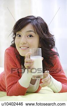Stock Photo - young woman drinking 
milk in bed. fotosearch 
- search stock 
photos, pictures, 
images, and photo 
clipart