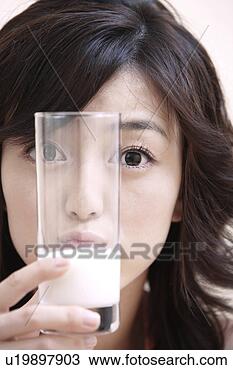 Stock Photo - young woman holding 
a glass of milk. 
fotosearch - search 
stock photos, 
pictures, images, 
and photo clipart
