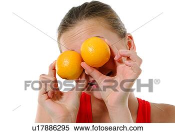 Stock Image - close-up of a 
young woman holding 
two oranges in 
front of her eyes. 
fotosearch - search 
stock photos, 
pictures, images, 
and photo clipart
