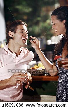 Stock Photo - woman feeding 
man in a bar. 
fotosearch - search 
stock photos, 
pictures, images, 
and photo clipart