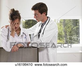 Stock Photography - doctors discussing 
a matter. fotosearch 
- search stock 
photos, pictures, 
images, and photo 
clipart