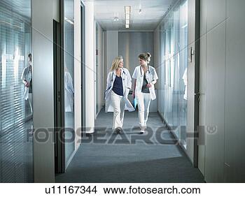 Stock Photo - two female doctors 
walking in a lobby 
of a hospital. 
fotosearch - search 
stock photos, 
pictures, images, 
and photo clipart