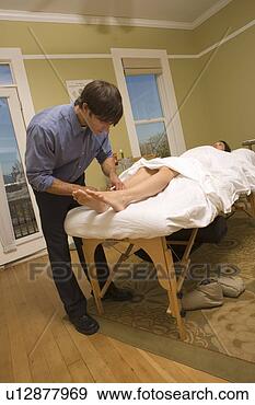 Stock Photograph - acupuncturist 
working on woman's 
feet. fotosearch 
- search stock 
photos, pictures, 
images, and photo 
clipart
