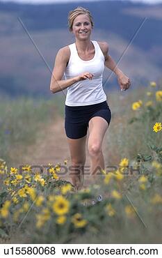 Stock Photo - caucasian woman 
jogging through 
a meadow of yellow 
daisies. fotosearch 
- search stock 
photos, pictures, 
images, and photo 
clipart
