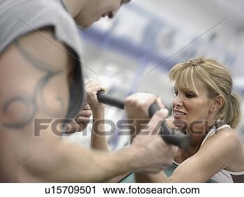 Stock Photography - caucasian female 
working out with 
tattooed male 
trainer. fotosearch 
- search stock 
photos, pictures, 
images, and photo 
clipart