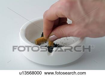 Stock Photography - females hand stubbing 
out a cigarette 
in an ashtray. 
fotosearch - search 
stock photos, 
pictures, images, 
and photo clipart