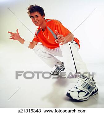 Stock Photo - young asian man 
with latest athletic 
shoes and gear. 
fotosearch - search 
stock photos, 
pictures, images, 
and photo clipart