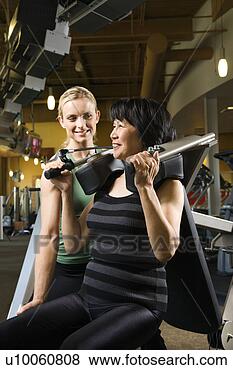 Stock Photo - prime adult caucasian 
female trainer 
helping asian 
mature adult. 
fotosearch - search 
stock photos, 
pictures, images, 
and photo clipart