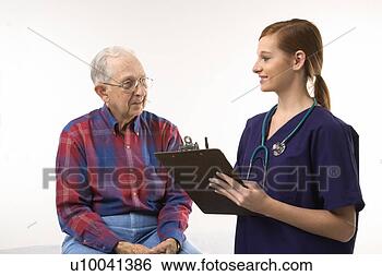 Stock Photo - mid-adult caucasian 
female in scrubs 
taking notes from 
elderly. fotosearch 
- search stock 
photos, pictures, 
images, and photo 
clipart