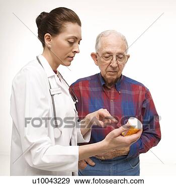 Stock Photograph - mid-adult caucasian 
female doctor 
pointing at prescription 
bottle as. fotosearch 
- search stock 
photos, pictures, 
images, and photo 
clipart