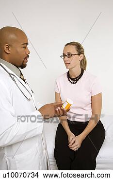 Stock Photo - mid-adult african-american 
doctor explaining 
medication to 
caucasion. fotosearch 
- search stock 
photos, pictures, 
images, and photo 
clipart