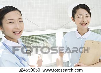 Stock Photography - portrait of two 
nurses,  twin 
sisters,  smiling 
and looking at. 
fotosearch - search 
stock photos, 
pictures, images, 
and photo clipart