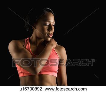 Stock Photo - african american 
young adult woman 
in sports bra 
with hand on. 
fotosearch - search 
stock photos, 
pictures, images, 
and photo clipart