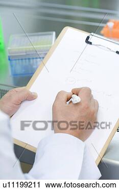 Stock Photography - close-up human 
hands writing 
a document in 
laboratory,  high 
angel. fotosearch 
- search stock 
photos, pictures, 
images, and photo 
clipart