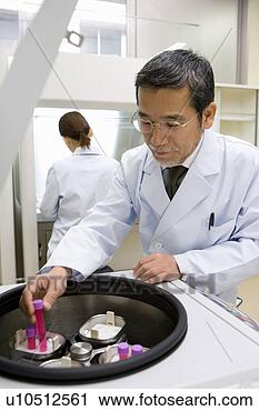 Stock Photography - mature scientist 
man taking out 
a test tube from 
a  centrifuge. 
fotosearch - search 
stock photos, 
pictures, images, 
and photo clipart