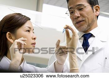 Stock Photo - two scientists 
talking in laboratory, 
 young woman looking 
at a test. fotosearch 
- search stock 
photos, pictures, 
images, and photo 
clipart
