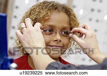 Stock Image - african american 
girl trying on 
glasses. fotosearch 
- search stock 
photos, pictures, 
images, and photo 
clipart