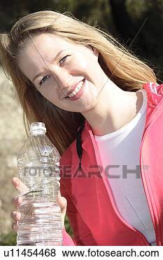 Stock Photo - female jogger 
holding water 
bottle, portrait. 
fotosearch - search 
stock photos, 
pictures, images, 
and photo clipart