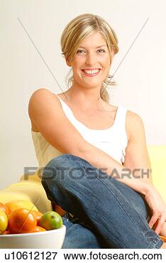 Picture - woman with bowl 
of citrus fruit 
in foreground. 
fotosearch - search 
stock photos, 
pictures, images, 
and photo clipart