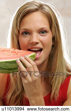 Stock Photo - young woman with 
long blond hair 
eating a slice 
of watermelon. 
fotosearch - search 
stock photos, 
pictures, images, 
and photo clipart