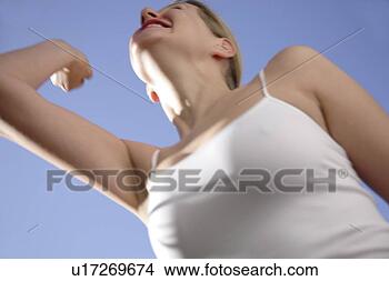 Stock Photo - young woman in 
a happy mood in 
front of blue 
sky, view from 
below. fotosearch 
- search stock 
photos, pictures, 
images, and photo 
clipart
