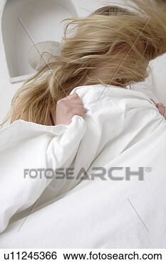 Stock Photo - young blond woman 
sitting up in 
bed and tossing 
her long hair. 
fotosearch - search 
stock photos, 
pictures, images, 
and photo clipart