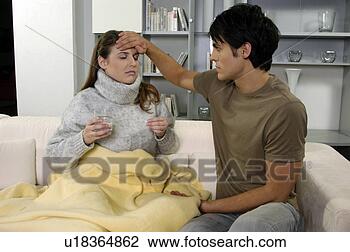 Stock Photo - young man feeling 
sick girlfriend's 
temperature,  
with his hand 
on. fotosearch 
- search stock 
photos, pictures, 
images, and photo 
clipart