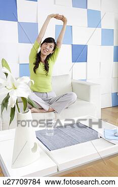 Stock Photo - young woman sitting 
and making a long 
arm. fotosearch 
- search stock 
photos, pictures, 
images, and photo 
clipart
