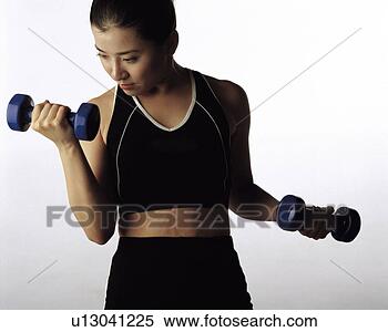 Stock Image - young woman exercising 
with dumbbell. 
fotosearch - search 
stock photos, 
pictures, images, 
and photo clipart