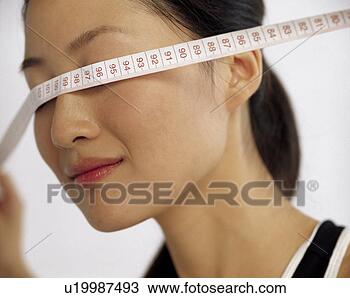 Stock Photo - young woman and 
ruler. fotosearch 
- search stock 
photos, pictures, 
images, and photo 
clipart