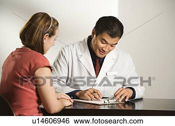 Stock Photo - asian american 
male doctor consulting 
with caucasian 
female patient. 
fotosearch - search 
stock photos, 
pictures, images, 
and photo clipart