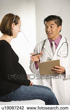 Stock Photo - asian american 
male doctor examining 
caucasian pregnant 
female patient. 
fotosearch - search 
stock photos, 
pictures, images, 
and photo clipart