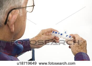 Stock Photograph - profile view of 
caucasion elderly 
man holding seven-day 
pill box with. 
fotosearch - search 
stock photos, 
pictures, images, 
and photo clipart